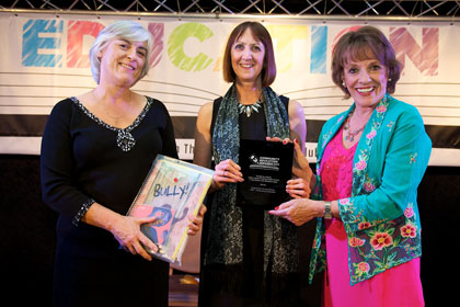 Jill Evans (centre) receives The Barney & Echo Action Against Bullying Project Award in association with Starshine Music from Ruth Kenward representing Starshine Music and Esther Rantzen CBE | Community Education Awards with Community Initiative Associates